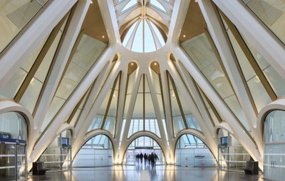 The image showcases a modern architectural interior featuring a striking dome-shaped ceiling support