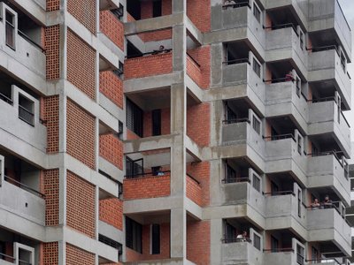Studio Frozen Music Replaces a Generic Nashik Tower with a Stepped Brick and Concrete Housing Block