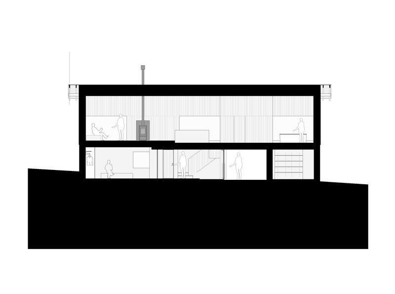 Section drawing showing two-story interior with central stove and stepped terrain