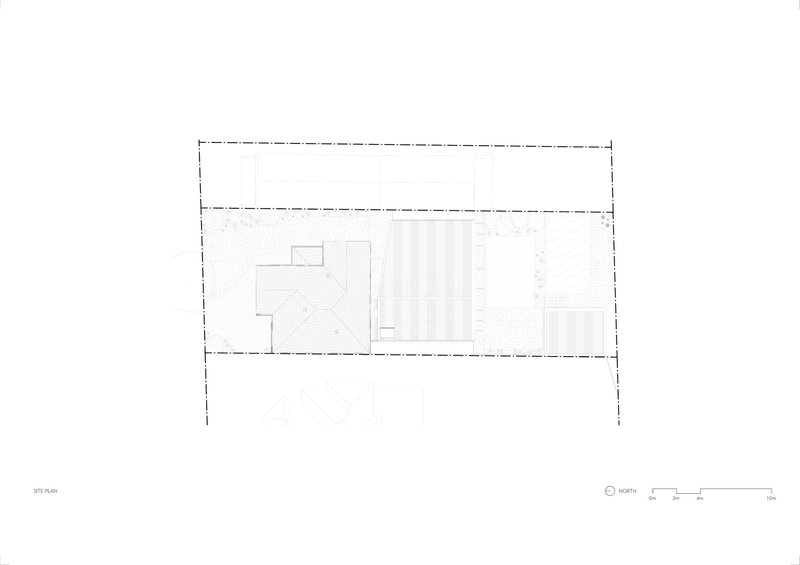 Site plan drawing showing a rectangular footprint with a central pool area flanked by enclosed spaces