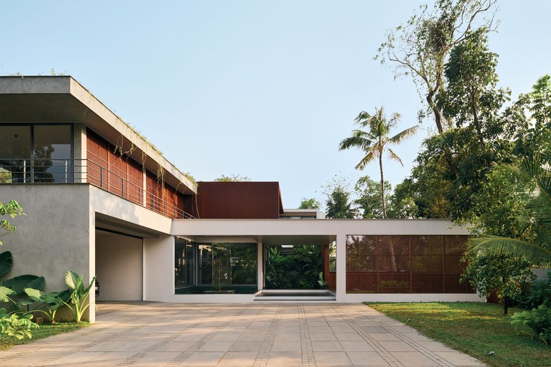 Front elevation showing the cantilevered concrete roof plane spanning between glazed and paneled volumes