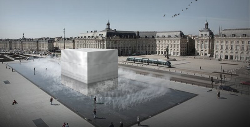 A reflective cubic volume anchors Cinemossa within the historic urban fabric, dissolving architecture into context while inviting exploration.