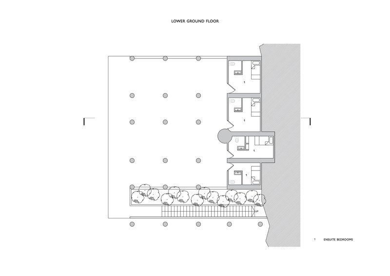 Lower ground floor plan showing open space with column grid and ensuite bedrooms along one edge