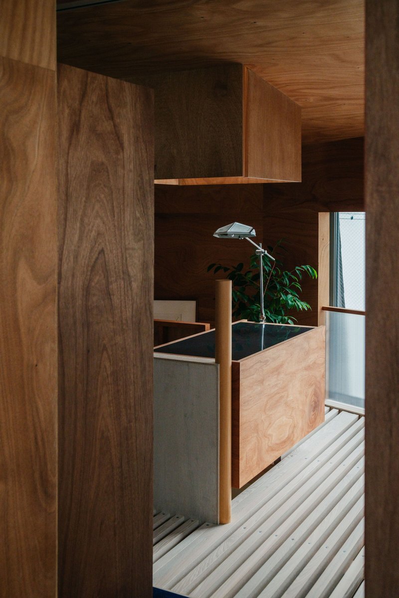 Walnut veneer cabinetry and built-in planter with corrugated metal flooring detail