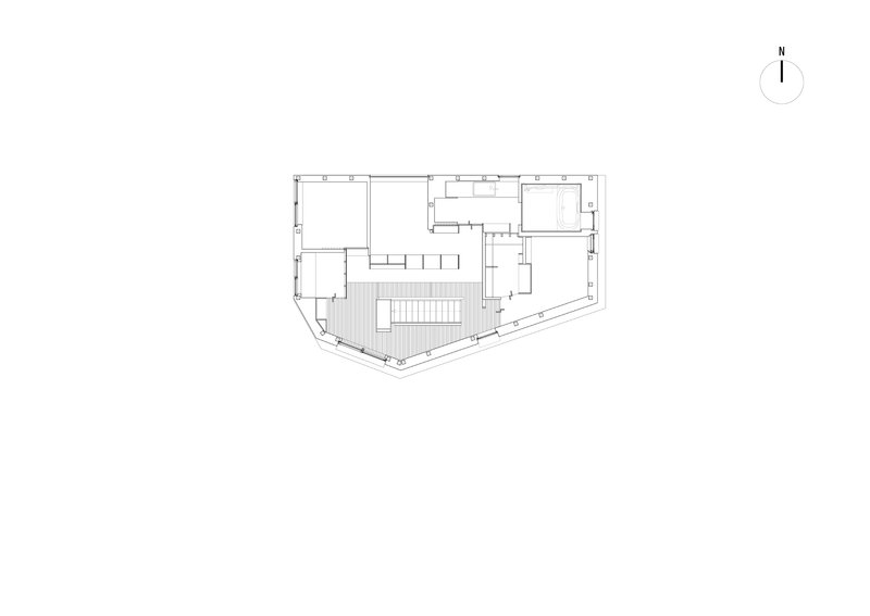 Floor plan drawing showing irregular trapezoidal site with central stair and surrounding rooms