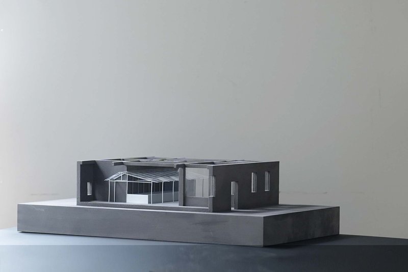 Physical model showing sectional cut through single-story structure with exposed roof framing