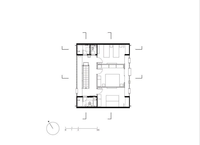Second floor plan showing bedroom suite with double bed and twin bathrooms flanking central stair