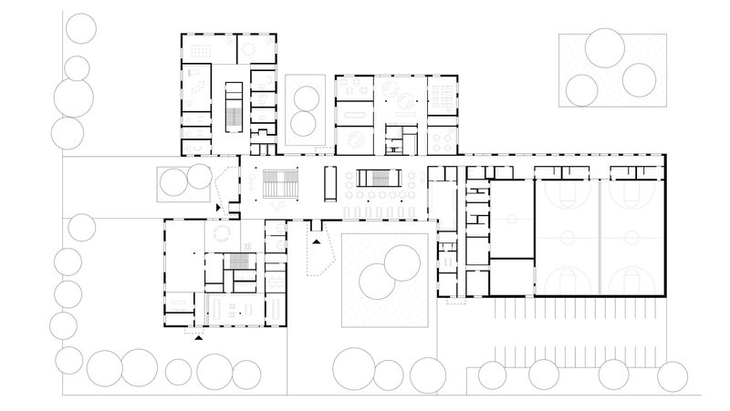 Floor plan drawing showing clustered rooms around courtyards with tree circles and adjacent gymnasium volume