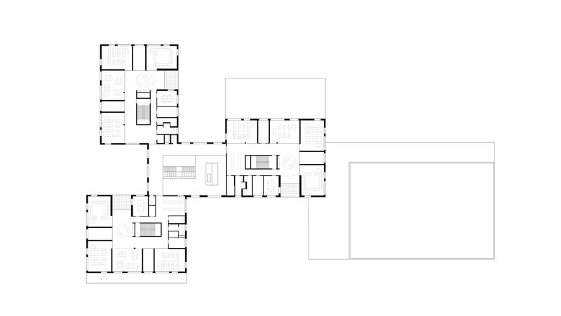 Floor plan drawing showing clustered wings around a central circulation core with a large rectangular volume