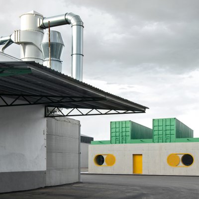 This architectural image showcases an industrial building with a modern design. The building feature