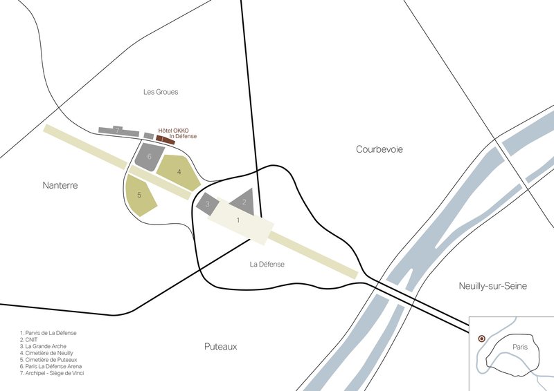 Site plan drawing showing multiple building zones along a river with roads and surrounding districts