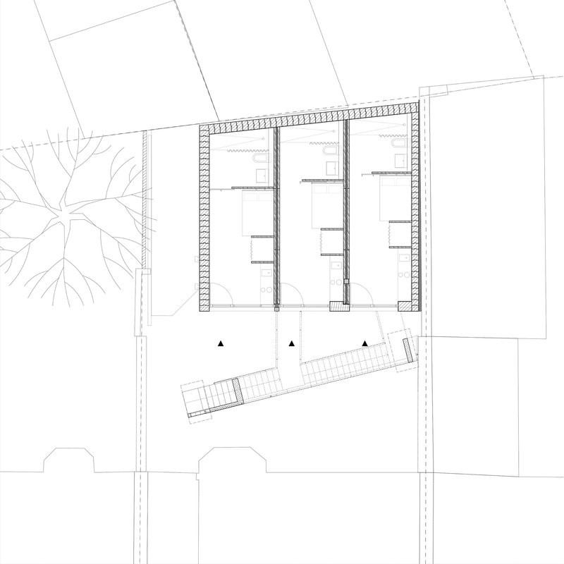 Ground floor plan drawing showing three parallel rooms with a diagonal staircase element and street trees