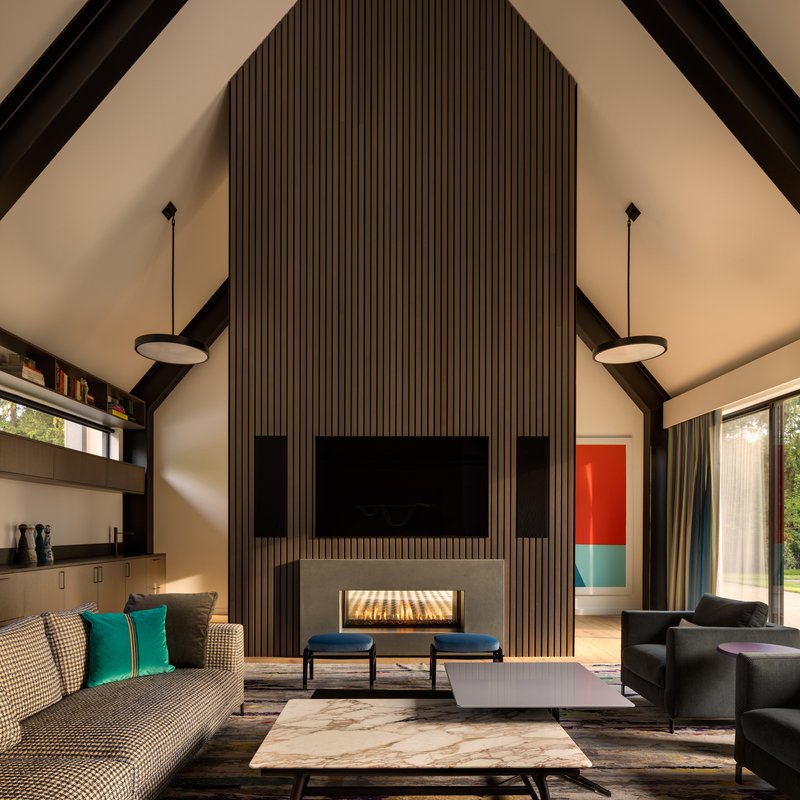 Vertical timber slat feature wall with recessed linear fireplace beneath a mounted television screen