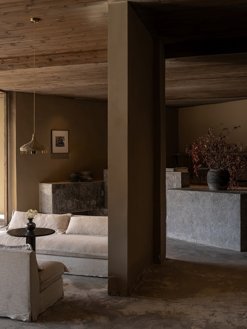 View through timber column to living space with pendant light and timber ceiling