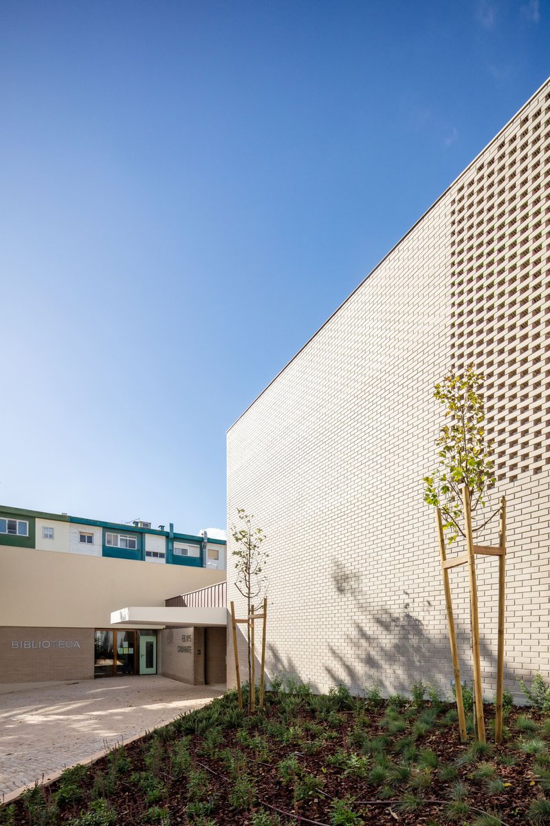 UMA Collective Wraps a Camarate School Around a Courtyard of Perforated Brick and Play