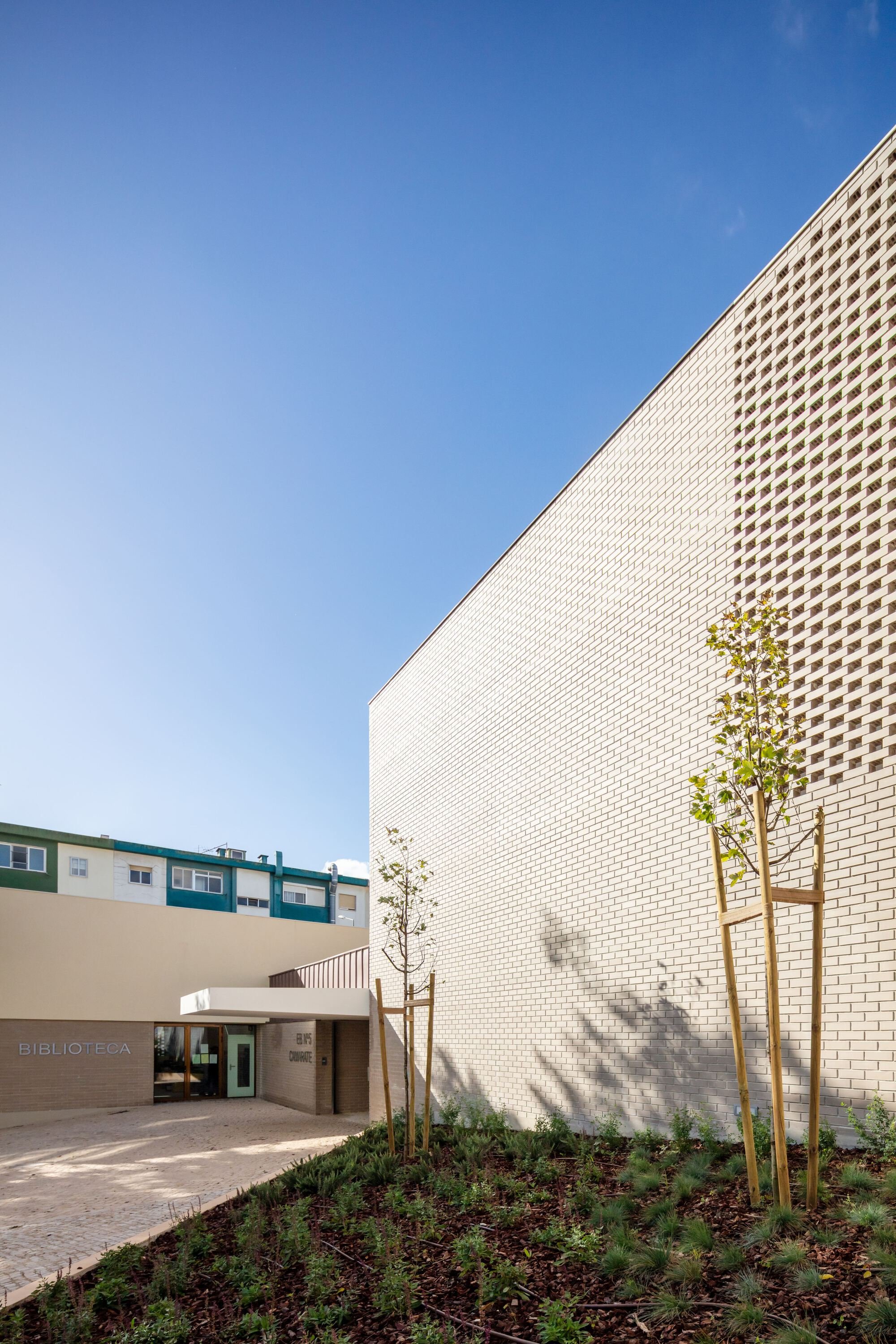 UMA Collective Wraps a Camarate School Around a Courtyard of Perforated Brick and Play