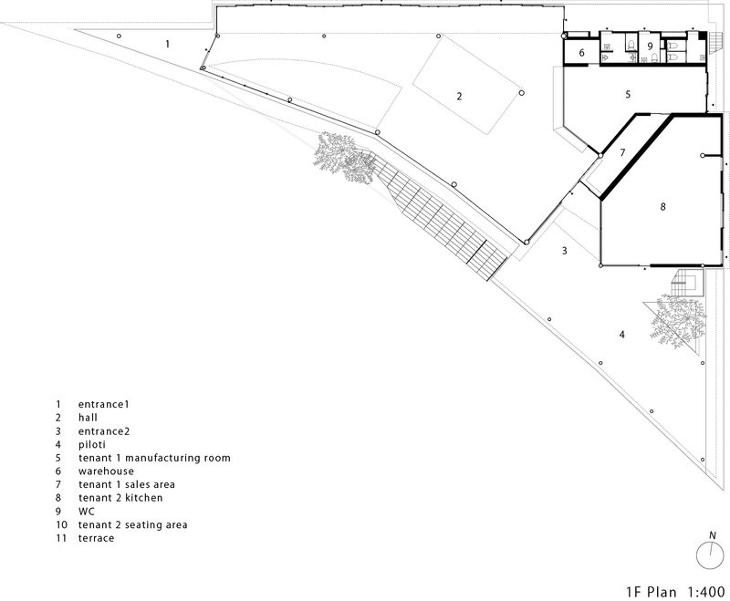 First floor plan drawing showing angled building footprint with labeled entrances, hall, and seating areas