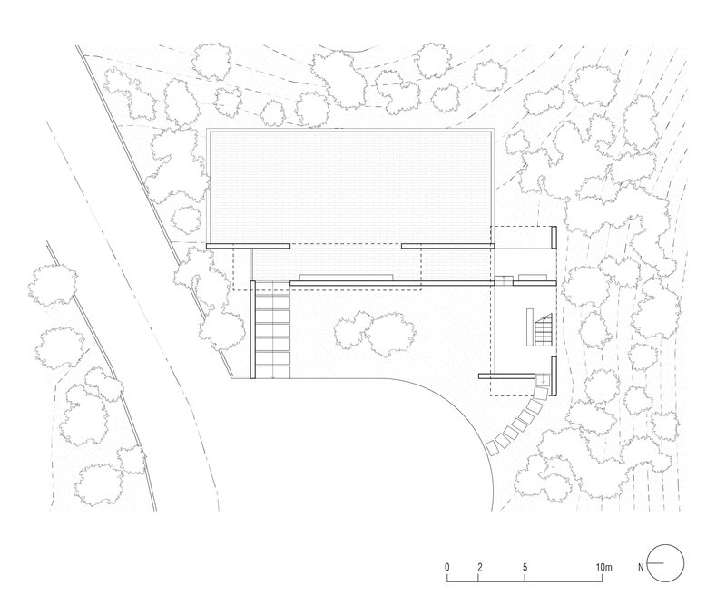 Floor plan drawing showing a rectangular volume with cantilevered terrace and stairs surrounded by trees