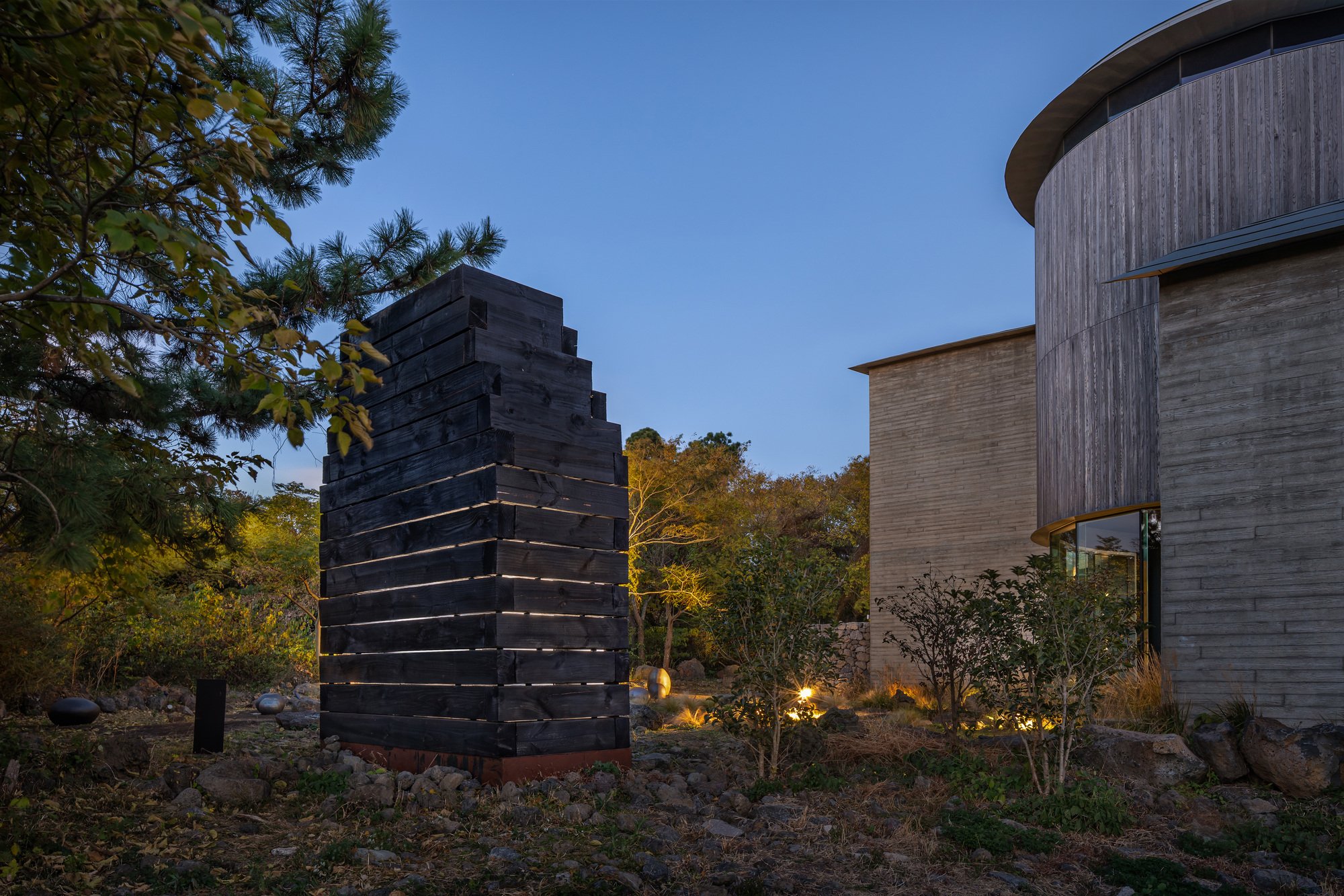DRAWING WORKS Stacks Charred Cedar Blocks into a Light-Filtering Pavilion on Jeju Island