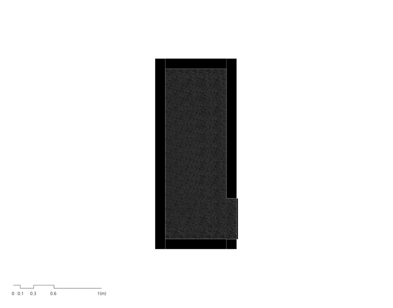 Floor plan drawing showing a narrow rectangular volume with a small notch on one edge