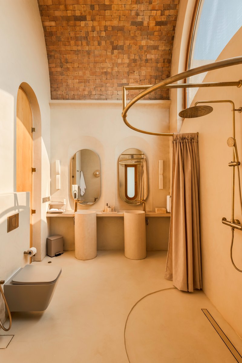 Bathroom interior with woven timber ceiling panel and polished plaster twin vanities
