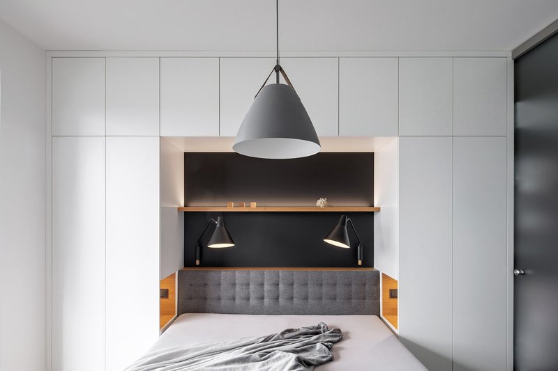 Integrated bedroom niche with soft lighting and built-in storage