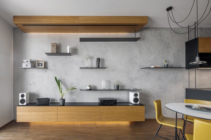Minimal living wall with floating shelves and warm underlighting
