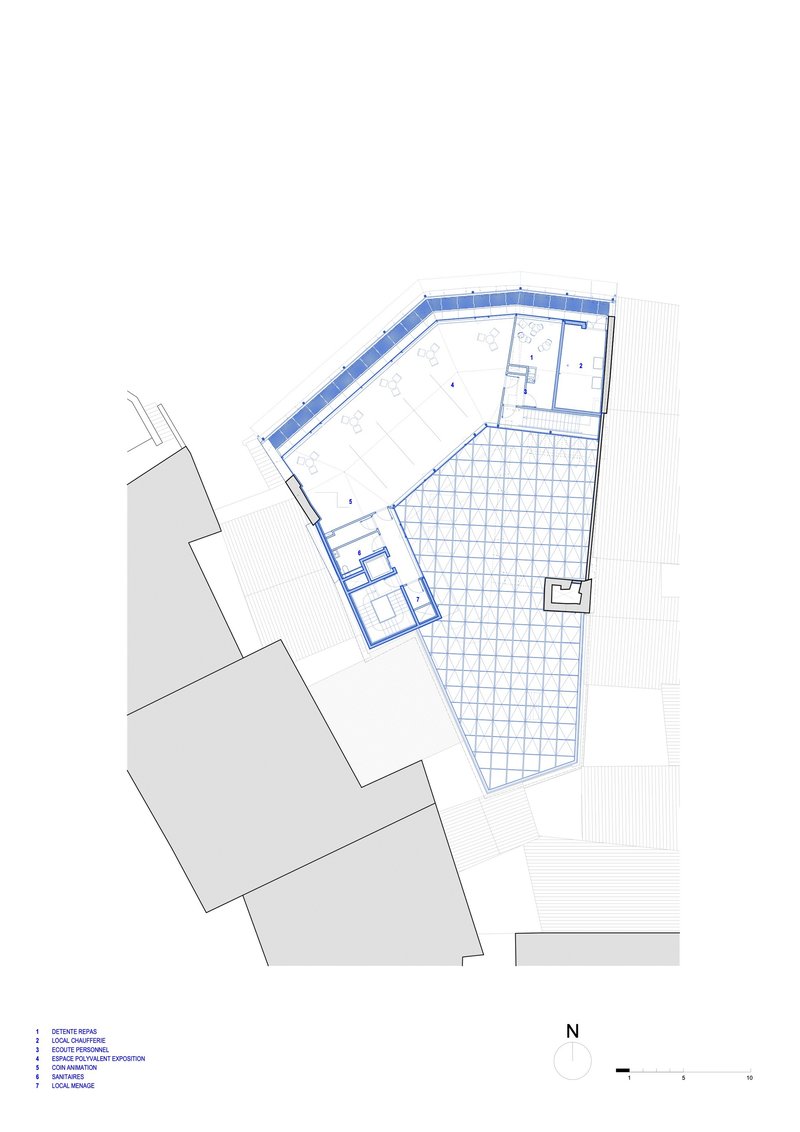 Floor plan drawing showing an angled volume with gridded courtyard adjacent to existing structures