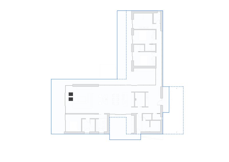 Floor plan drawing depicting the layout with central living zone connecting perpendicular bedroom and service wings