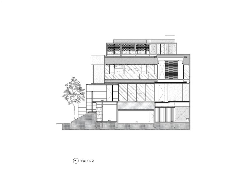 Section drawing showing layered interior spaces across four levels with rooftop solar panels