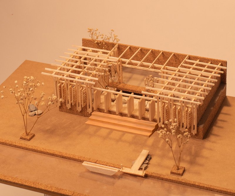 Physical model with exposed timber grid structure and planted courtyard under warm exhibition lighting