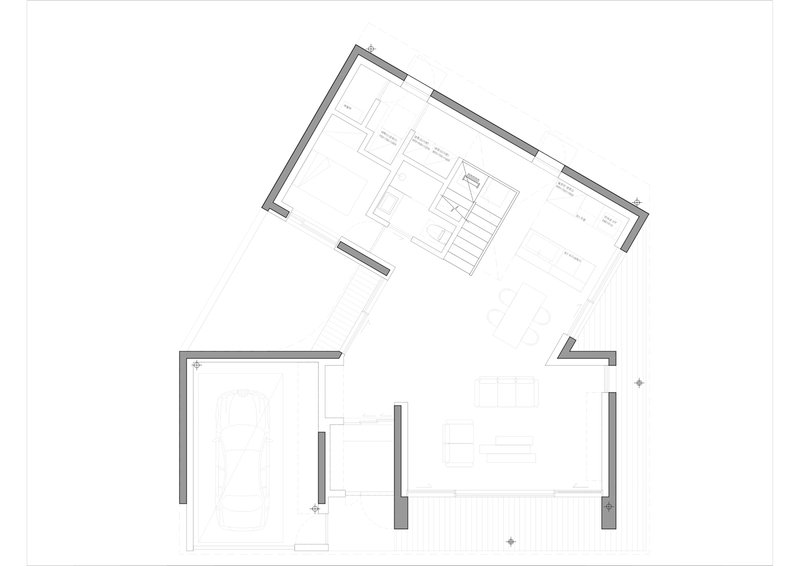 Floor plan drawing showing an angled layout with central staircase and open living areas