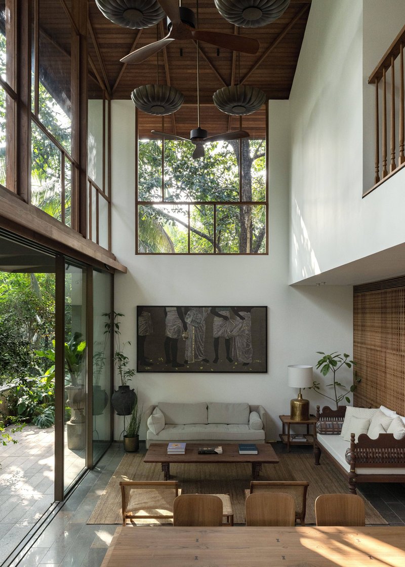 Interior view of the living room under exposed timber roof trusses and pendant lights