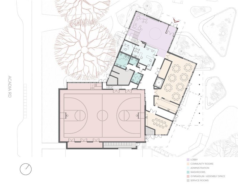 Floor plan drawing showing gymnasium, lobby, community rooms, and circulation with surrounding trees
