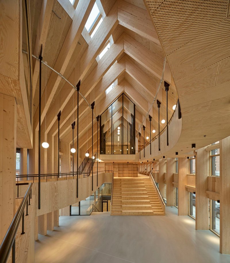 Vaulted timber ceiling above central staircase with suspended globe pendant lights and glass balustrades