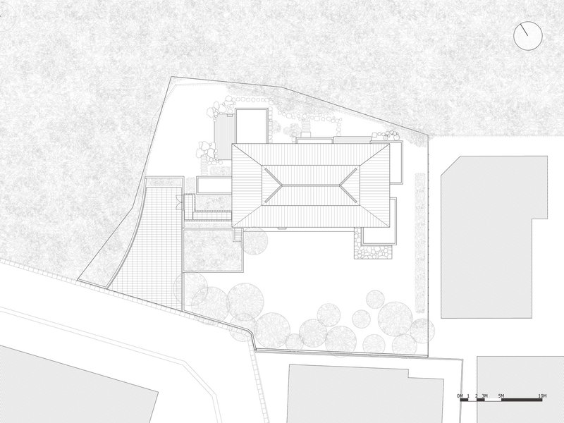 Roof plan drawing showing the angled metal roofs and surrounding garden with trees
