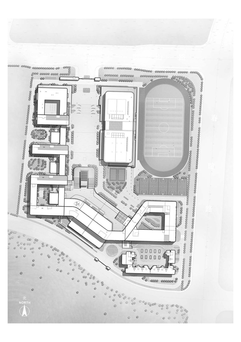 Site plan drawing showing multiple buildings arranged around a central running track and athletic field
