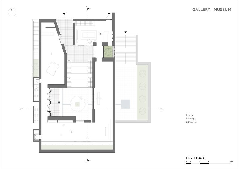 First floor plan showing lobby, gallery and showroom spaces with exterior planted areas