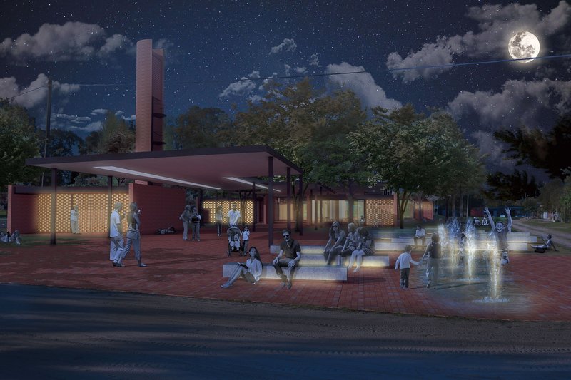 Night view of the community learning plaza activating public space through light, gathering, and informal interaction