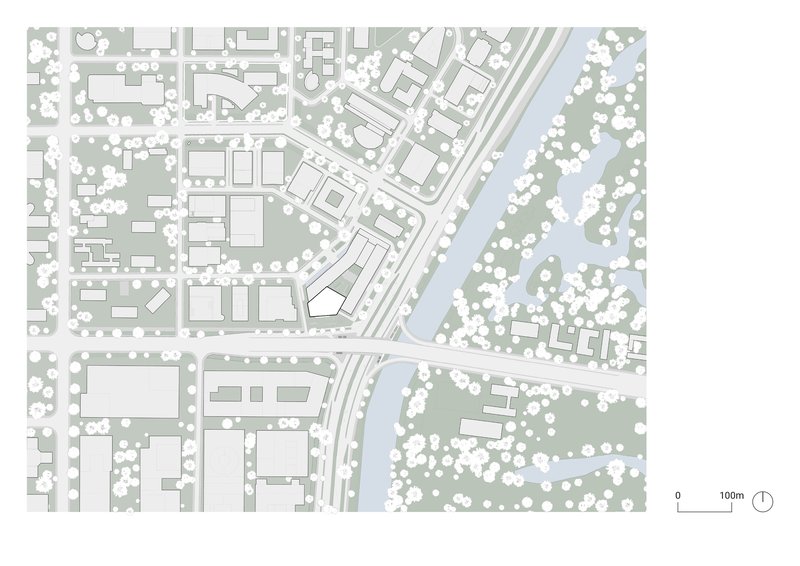 Site plan showing urban blocks with trees adjacent to a waterway and diagonal roadway