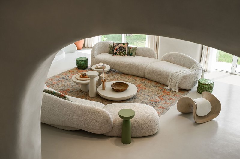 Overhead view of the sunken seating area with patterned rug and garden views through floor-to-ceiling windows