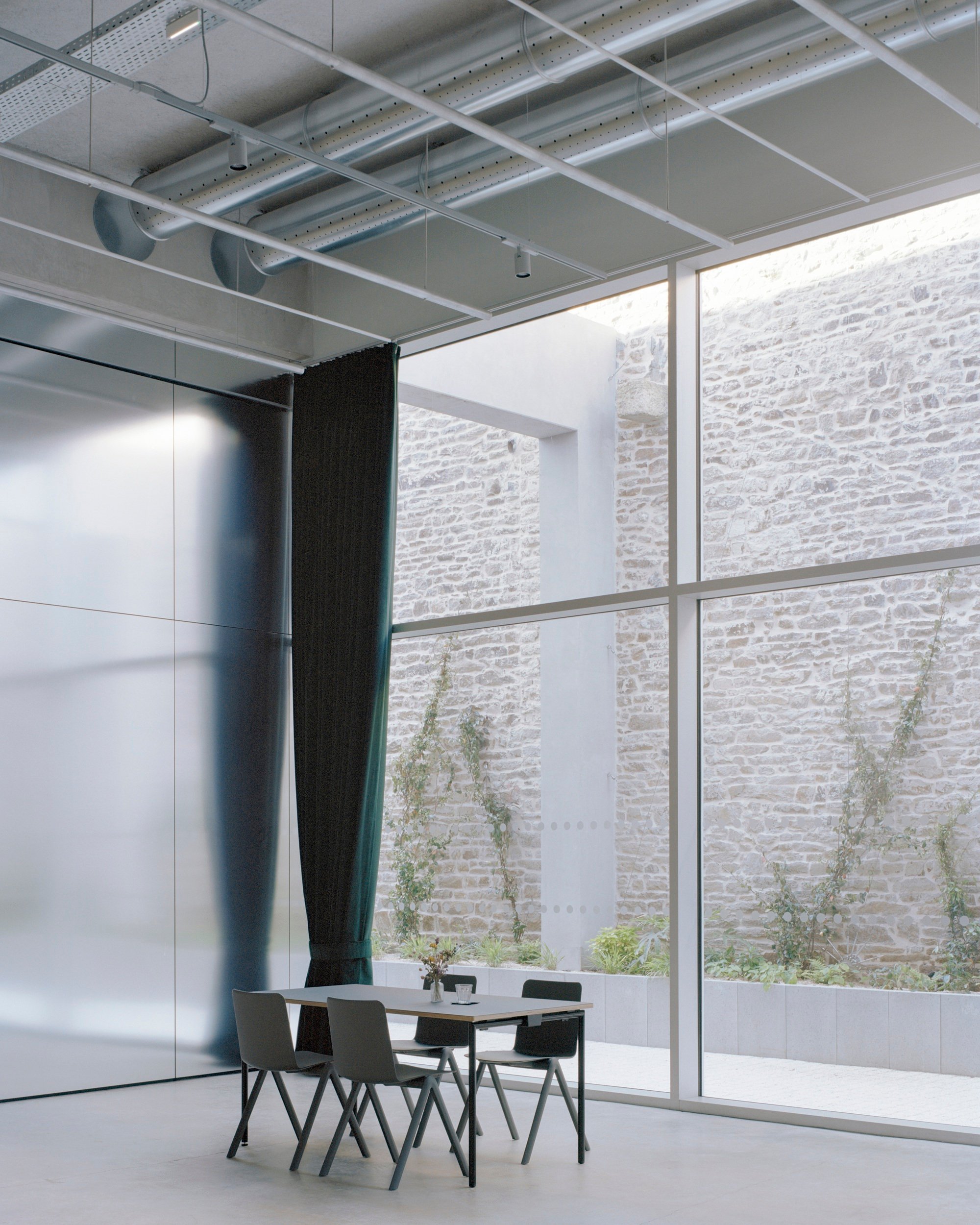 Office Zola Architectes Carves a Courtyard Out of a 44-Meter Industrial Hall in Vannes