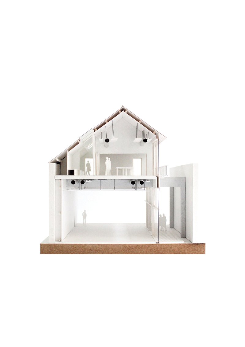 Section model showing a pitched-roof gabled house with two levels and miniature human figures inside