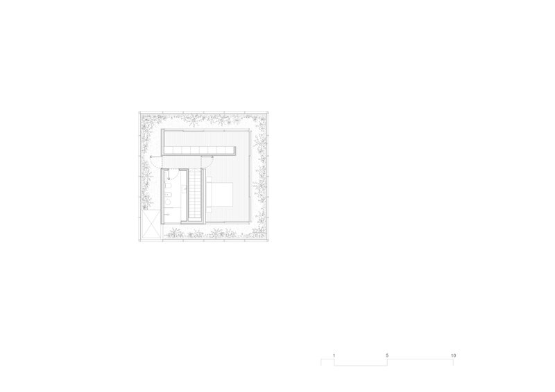 Site plan drawing showing the building footprint surrounded by landscaped areas with trees and plantings
