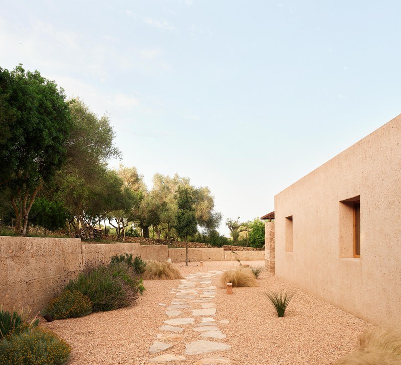 OAM Oficina d'Arquitectura Settles a Rammed Earth House into a Mallorcan Hillside