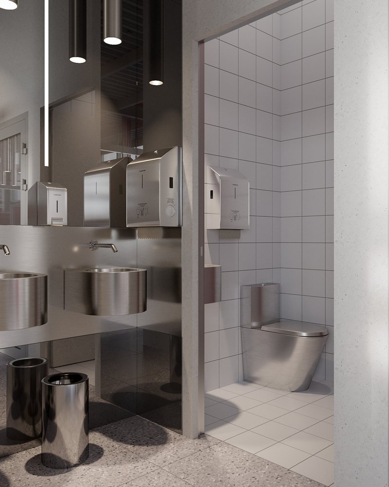 Restroom design featuring stainless steel fixtures and a refined utilitarian aesthetic.
