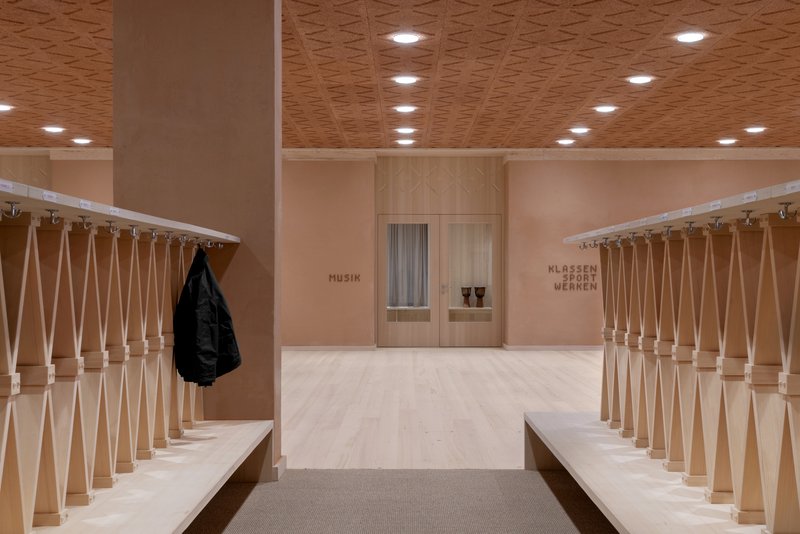 Entrance hallway with turned wood balustrades, bench seating, and a black jacket hung on the railing