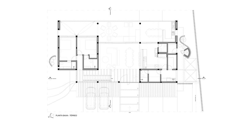 Ground floor plan drawing with central open space flanked by rooms and exterior decks
