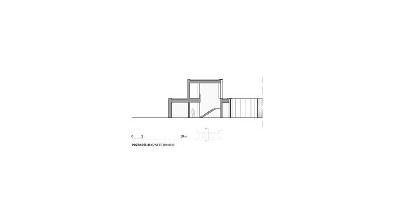 Section drawing showing interior levels and curved staircase connecting split-level spaces