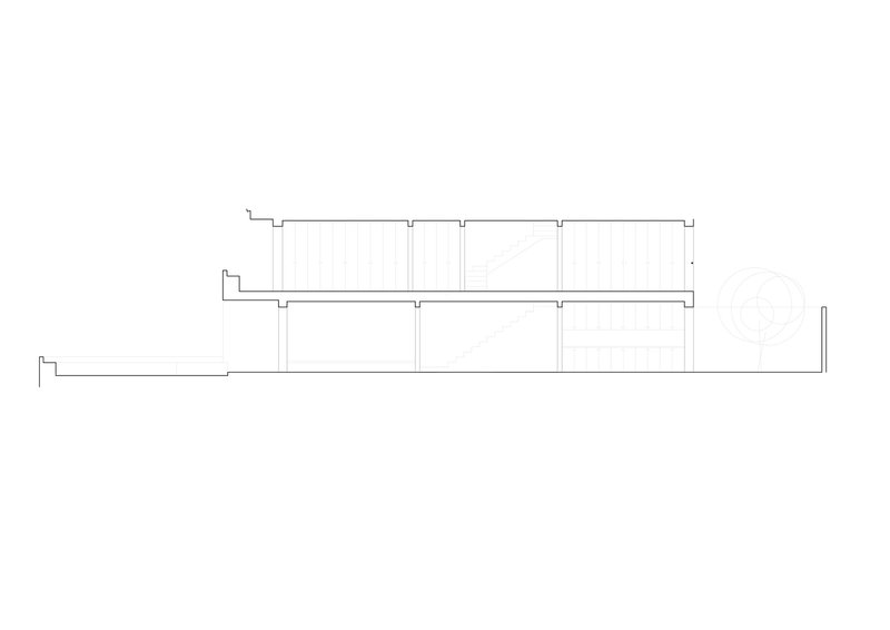 Section drawing showing a long horizontal volume with stepped roof levels and regular column spacing
